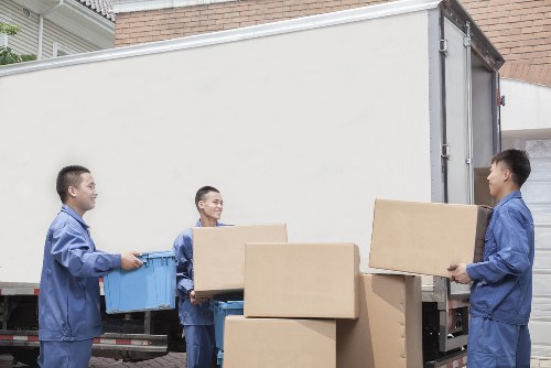 Local movers navigating a Docklands building entrance during a piano removal